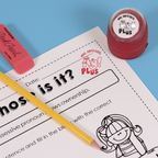 Red personalized teacher stamp with self-inking base, with a unique design featuring a teacher's name and a phrase 'Ay! Plus'.