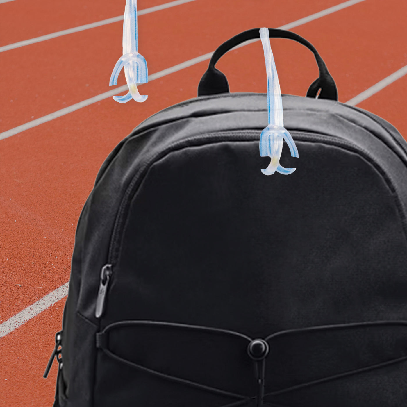 InchBug Sports Kids Circle Bag Tag attached to the zipper of a mesh-designed backpack. 