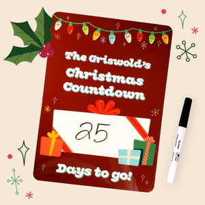 A personalized Christmas countdown board with a red background, featuring an illustration of Christmas lights and presents. The board has a white text that reads 'The Grisworld's Christmas Countdown' and '25' written on the central white Christmas gift drawing.