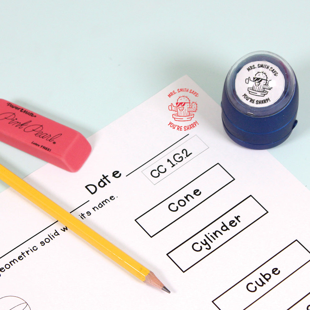 Dark blue personalized teacher stamp with self-inking base, with a unique design featuring a teacher's name and a phrase 'You're sharp!'.