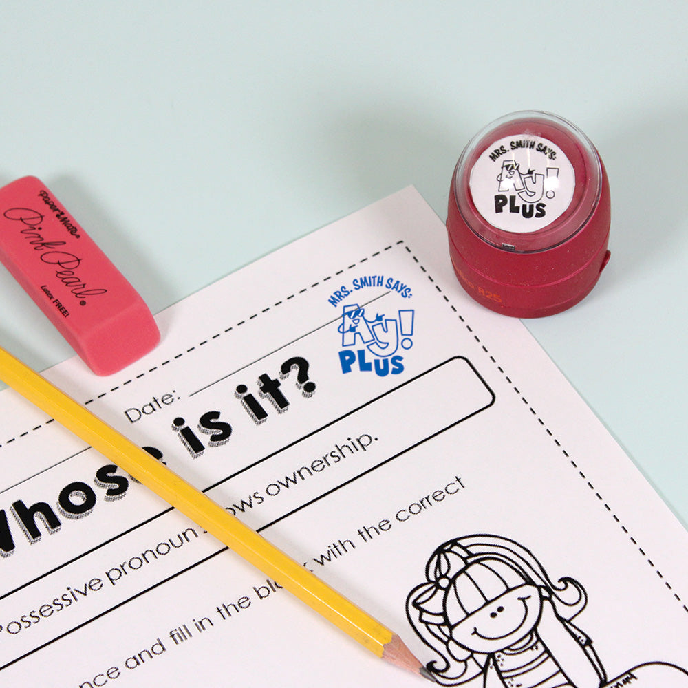 Dark red personalized teacher stamp with self-inking base, with a unique design featuring a teacher's name and a phrase 'Ay! Plus'.