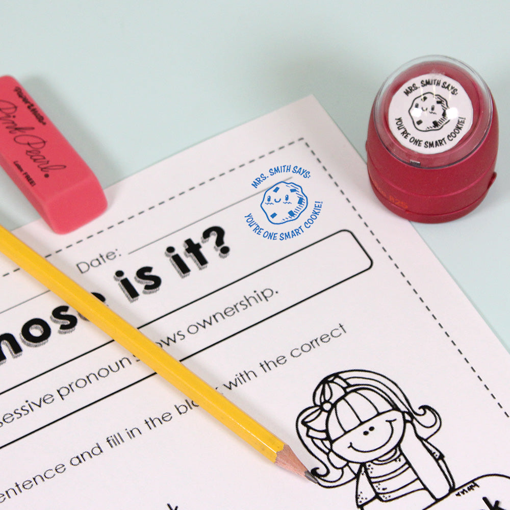 Dark red personalized teacher stamp with self-inking base, with a unique design featuring a teacher's name and a phrase 'You're one smart cookie!'.