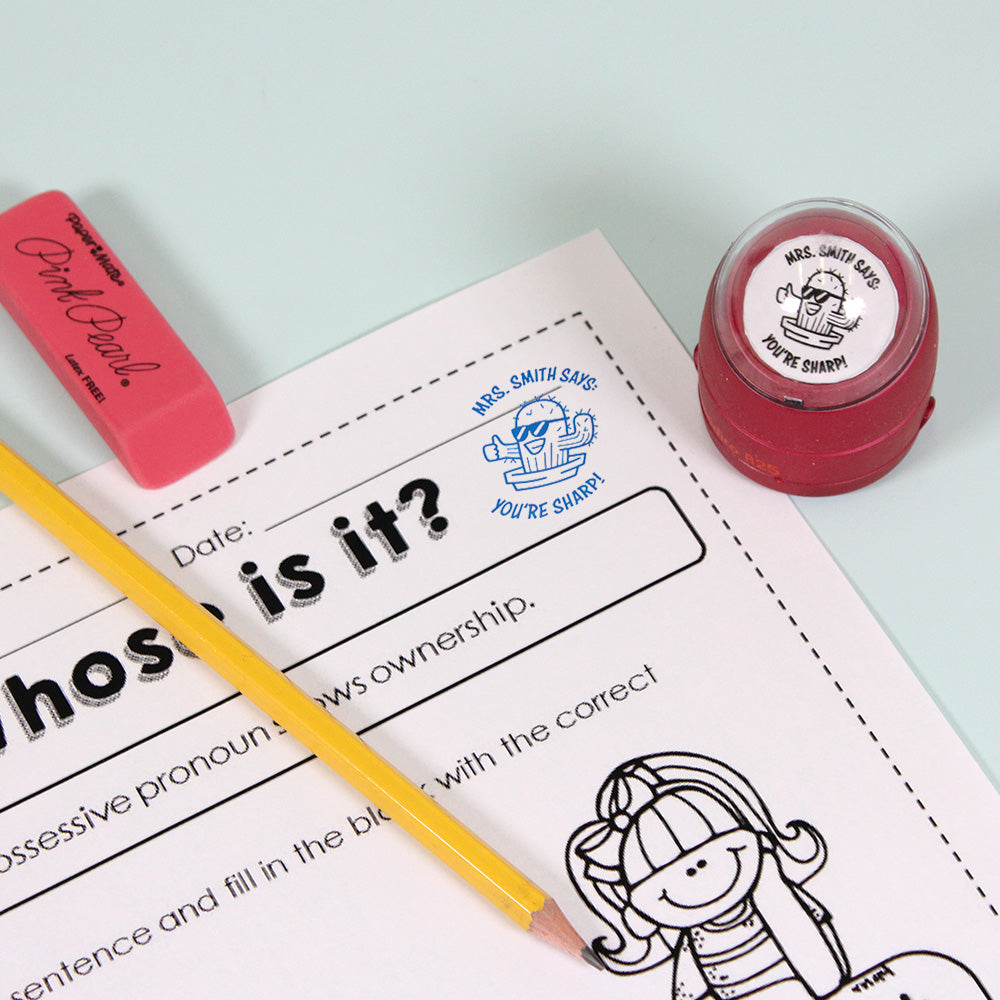 Dark red personalized teacher stamp with self-inking base, with a unique design featuring a teacher's name and a phrase 'You're sharp!'.
