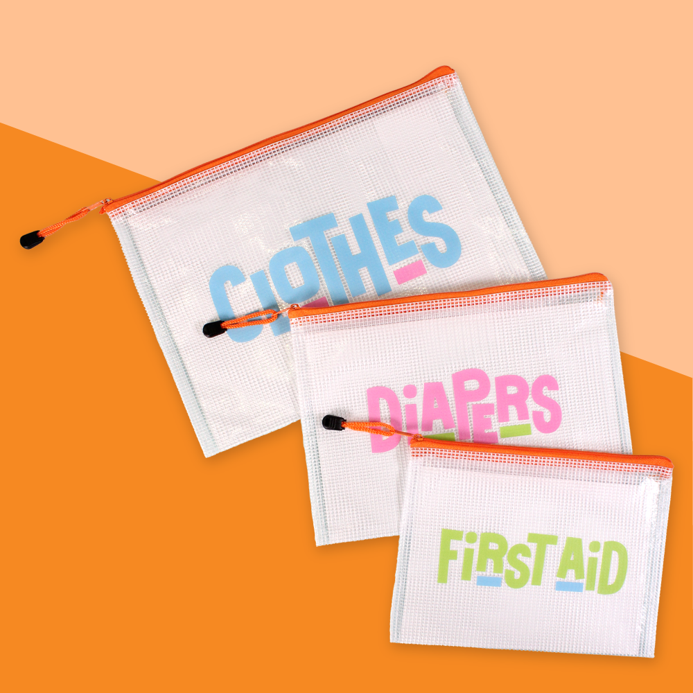 The InchBug 3-pack Diaper Bag Organizers placed on an orange two-tone background, one marked 'CLOTHES', one 'DIAPERS', and one 'FIRST AID'.