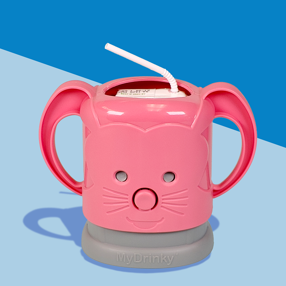 A pink InchBug MyDrinky adjustable juice box holder with a cartoon face and sturdy handles, attached to a grey base, designed to hold a juice box.