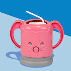 A pink InchBug MyDrinky adjustable juice box holder with a cartoon face and sturdy handles, attached to a grey base, designed to hold a juice box.