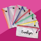 A collection of InchBug personalized water-resistant zipper pouches with different colored zippers and mesh designs. Each pouch is personalized with a name in black lettering.