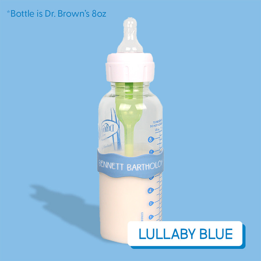 Baby bottle with baby blue InchBug Orbit Label on a light blue background, labeled 'Lullaby Blue'.