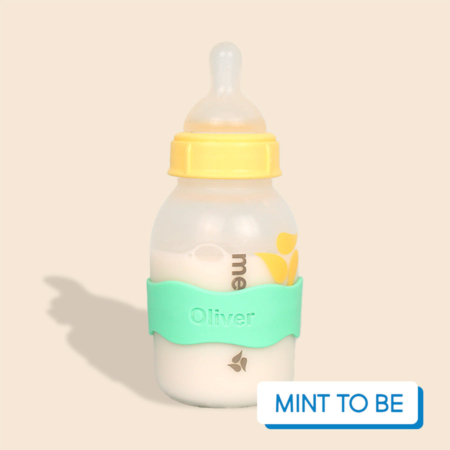 Baby bottle with mint green InchBug Orbit Label on a beige background, labeled 'Mint To Be'.