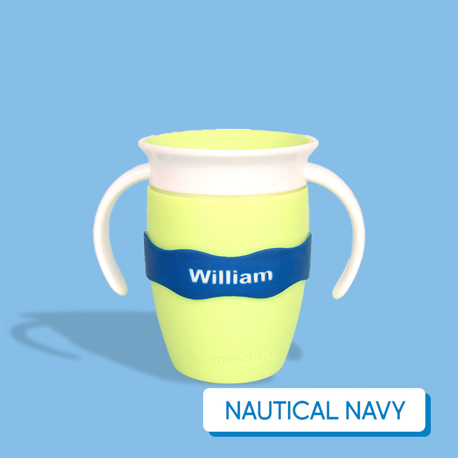 Yellow-green sippy cup with navy blue InchBug Orbit Label on a light blue background, labeled 'Nautical Navy'.