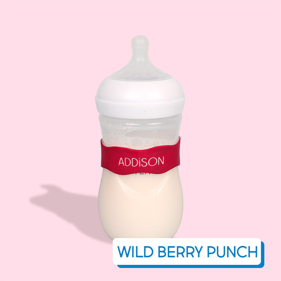 Baby bottle with red InchBug Orbit Label on a pink background, labeled 'Wild Berry Punch'.