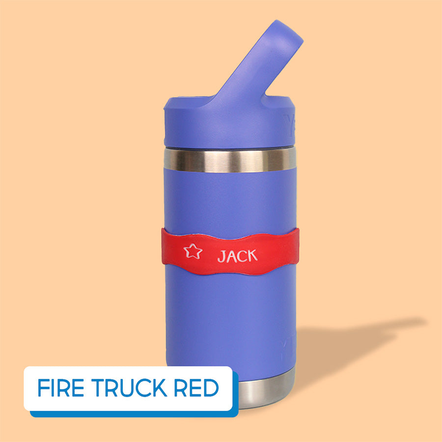 Purple water bottle with red label on a beige background, labeled with InchBug Orbit Labels® Personalized Water Bottle Label - Fire Truck Red