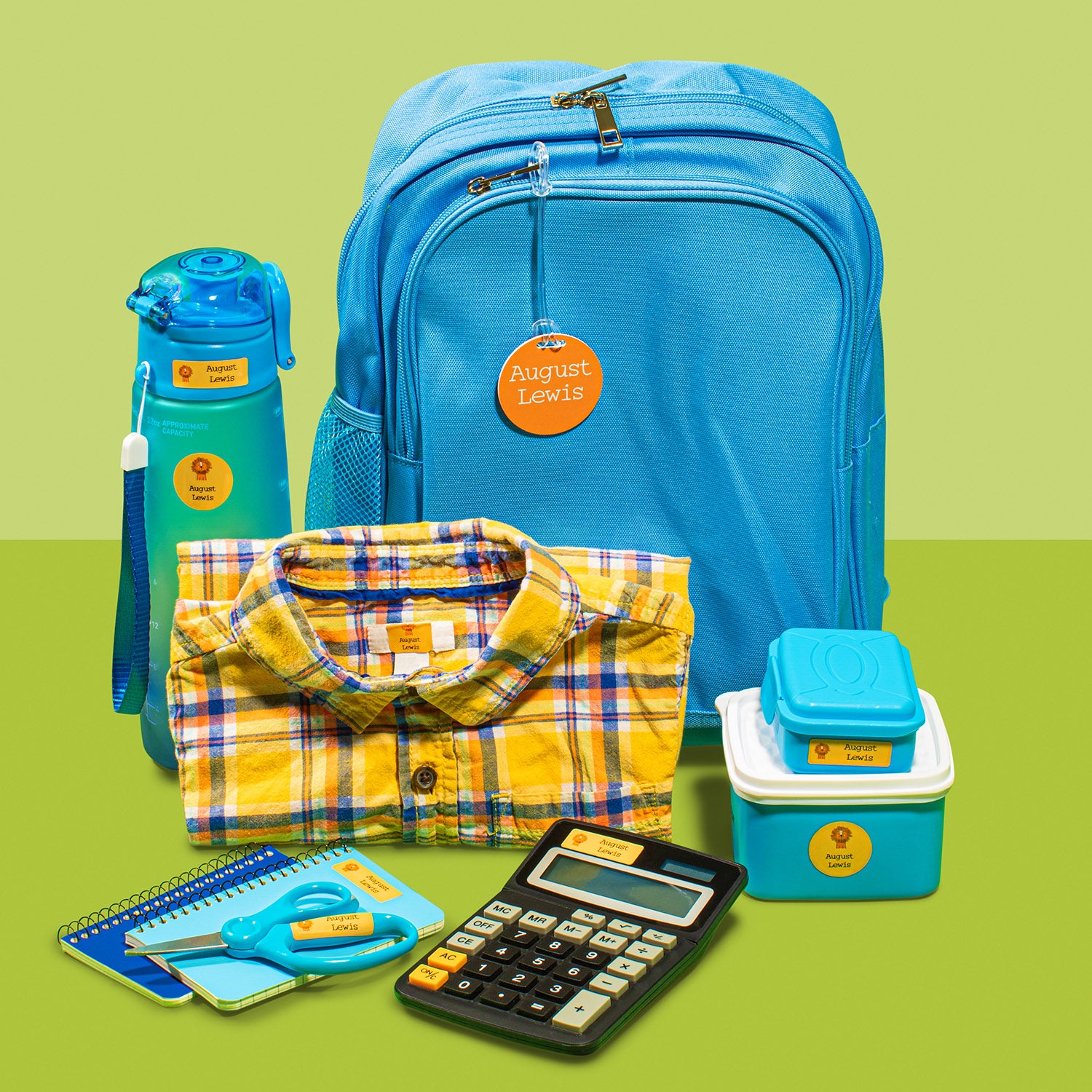 a blue backpack, blue water and food containers, yellow checkered clothing, and other school items labeled with yellow InchBug labels and bag tags, placed against a two-toned green background