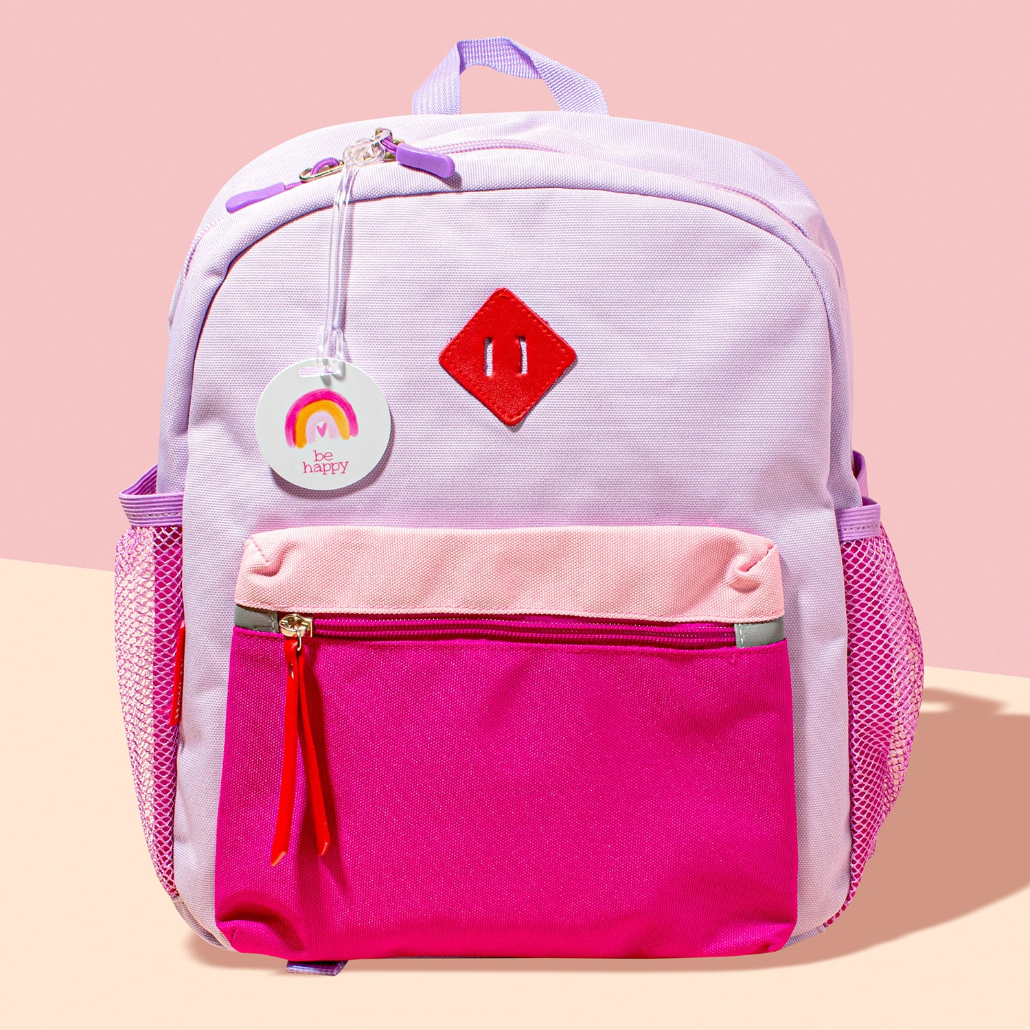 InchBug personalized kids bag tag attached to a purple and pink backpack with a plastic loop.