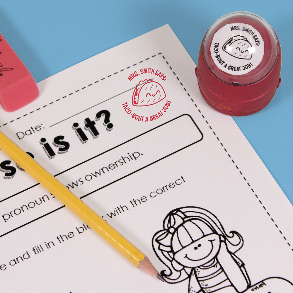 Red personalized teacher stamp with self-inking base, with a unique design featuring a teacher's name and a phrase 'Taco-bout a great job!'.