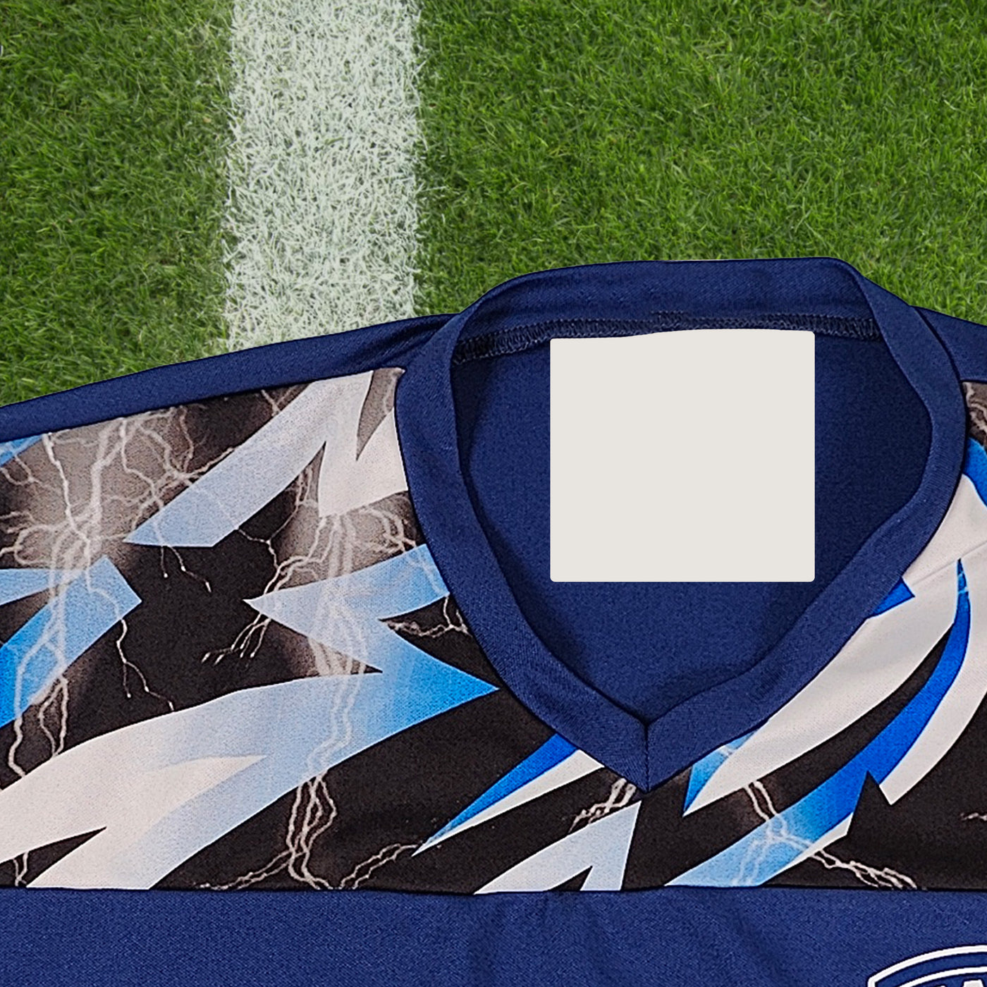 A baseball and a blue piece of clothing with InchBug clothes tags attached to them, presented on a two-tone background.