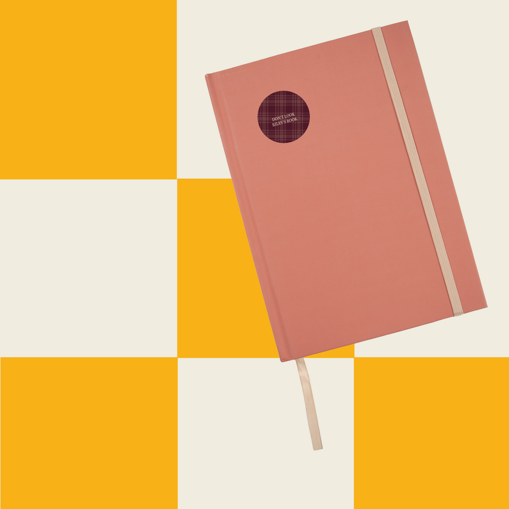 InchBug Circle Name Labels - Teen Line on orange notebook