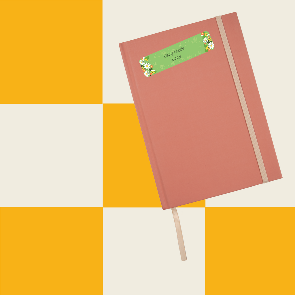 InchBug sticker name label on an orange notebook