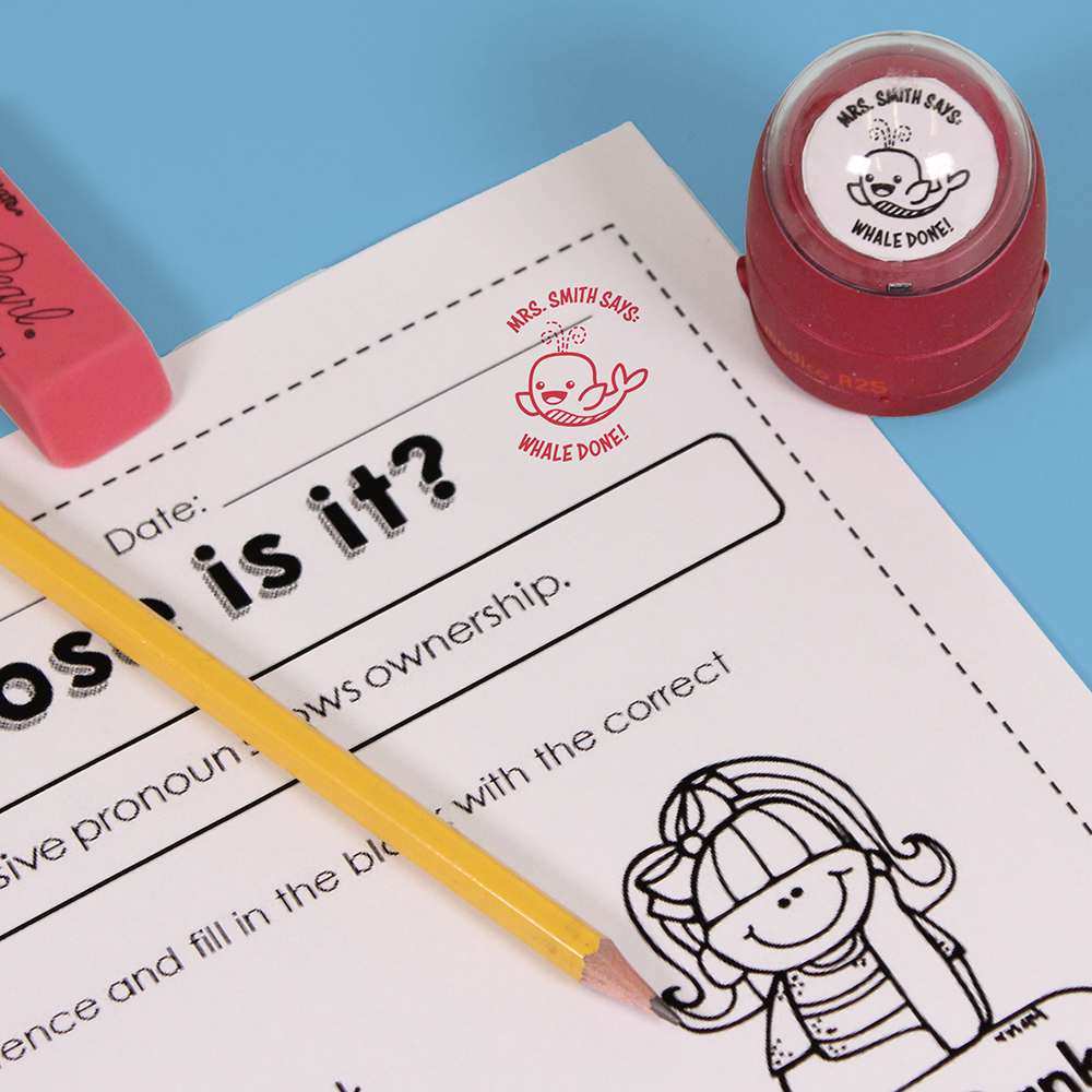 Red personalized teacher stamp with self-inking base, with a unique design featuring a teacher's name and a phrase 'Whale done!'.