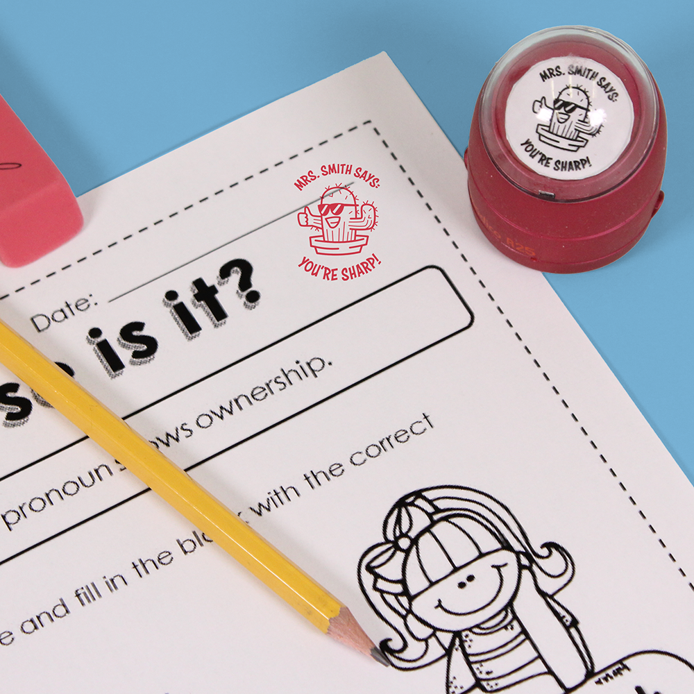 Red personalized teacher stamp with self-inking base, with a unique design featuring a teacher's name and a phrase 'You're sharp!'.