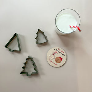 InchBug's personalized Christmas-themed coaster with Christmas tree cookie cutters and glass of milk with candy cane