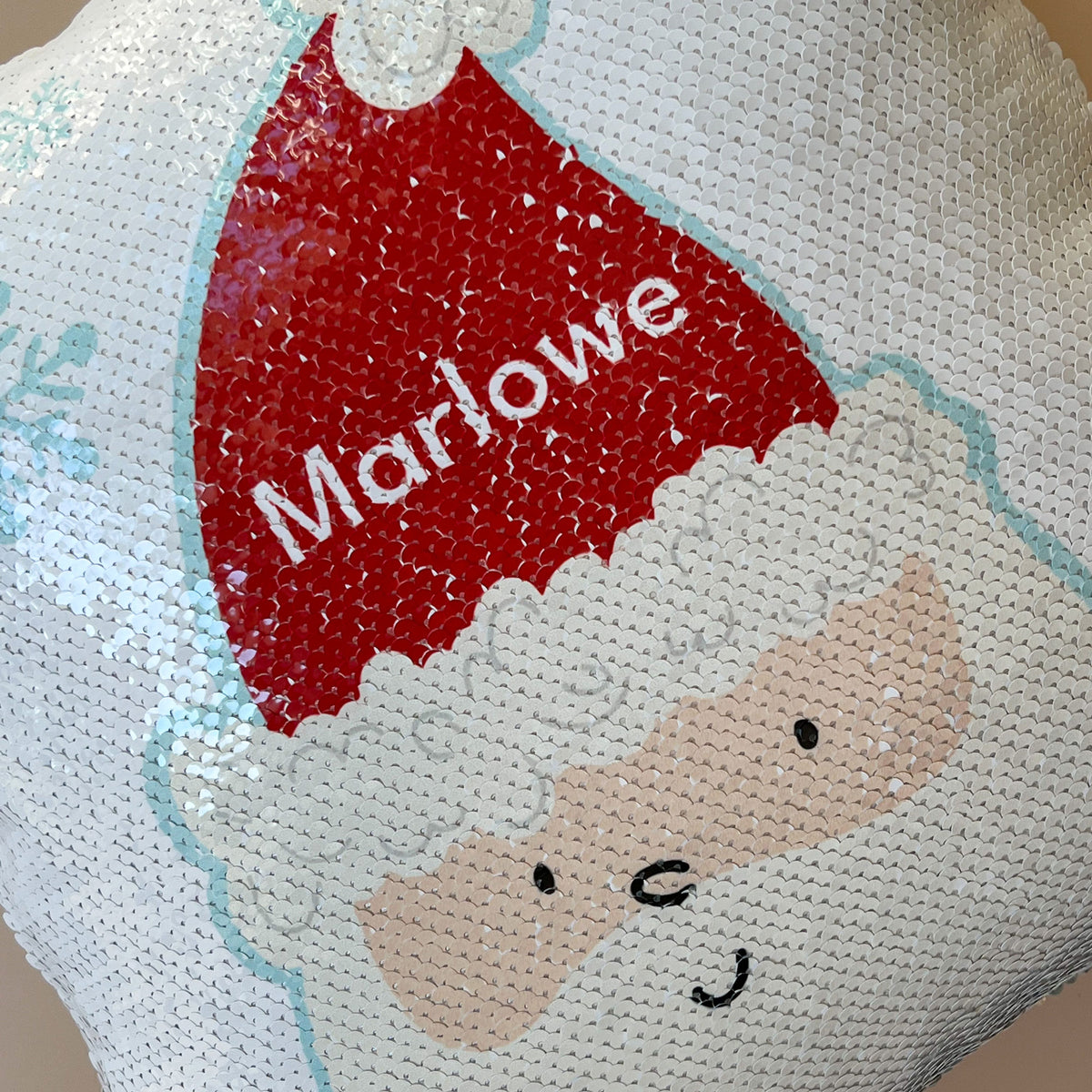close-up view of the sequined InchBug Silly Santa pillow
