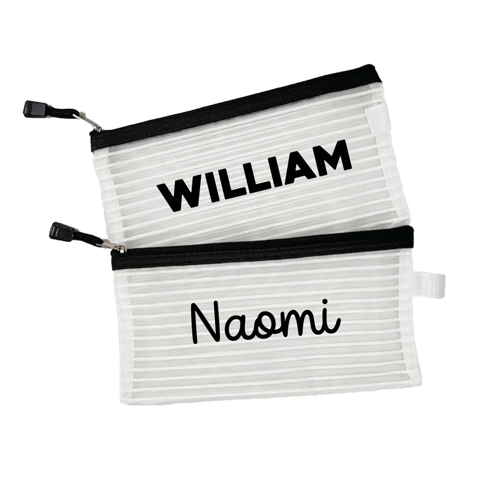 Two black InchBug personalized zipper pouches with the names 'WILLIAM' and 'Naomi' printed on them.