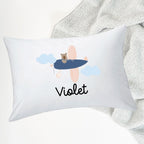 InchBug white pillow with the name 'Violet' printed on it, featuring a design with a bear and clouds, placed on top of a blanket.