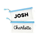 Two blue InchBug personalized zipper pouches with the names 'JOSH' and 'Charlotte' printed on them.