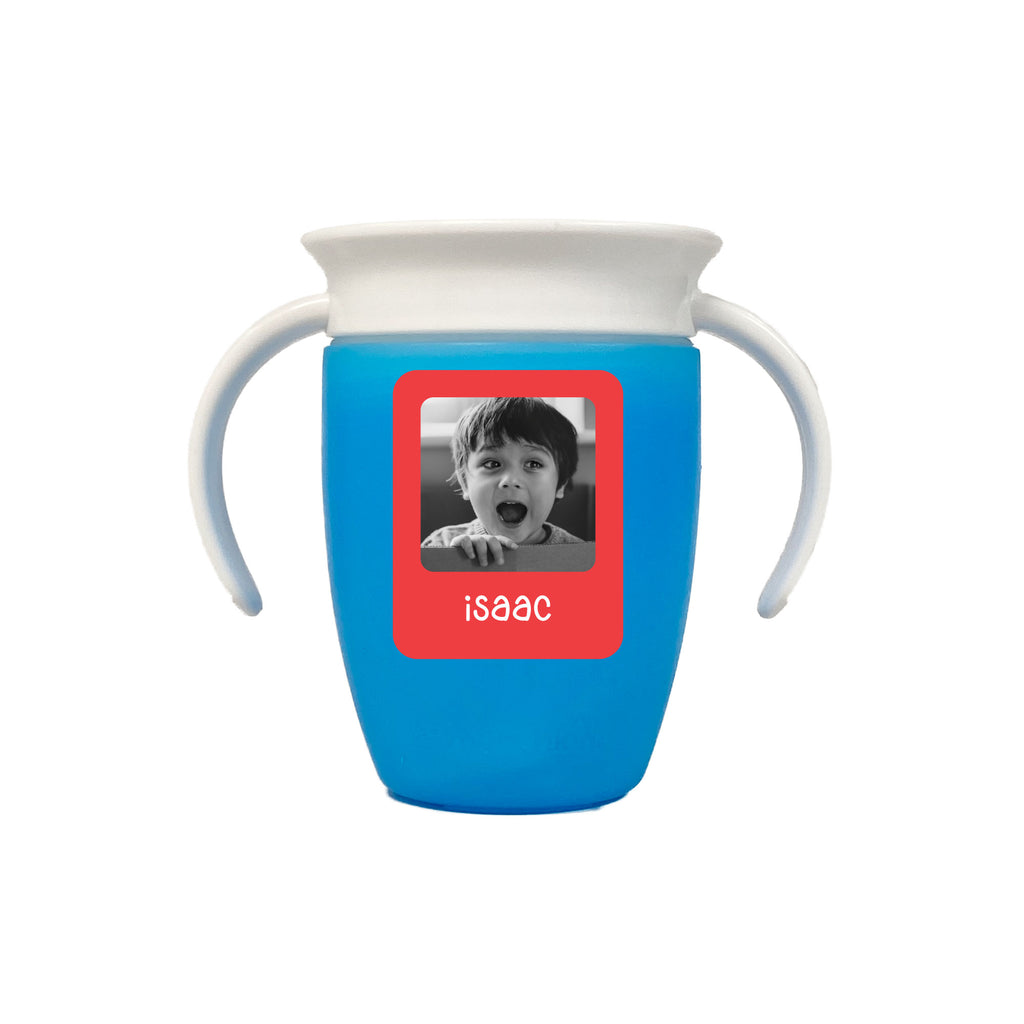 A blue sippy cup with a custom InchBug photo label featuring a child's face