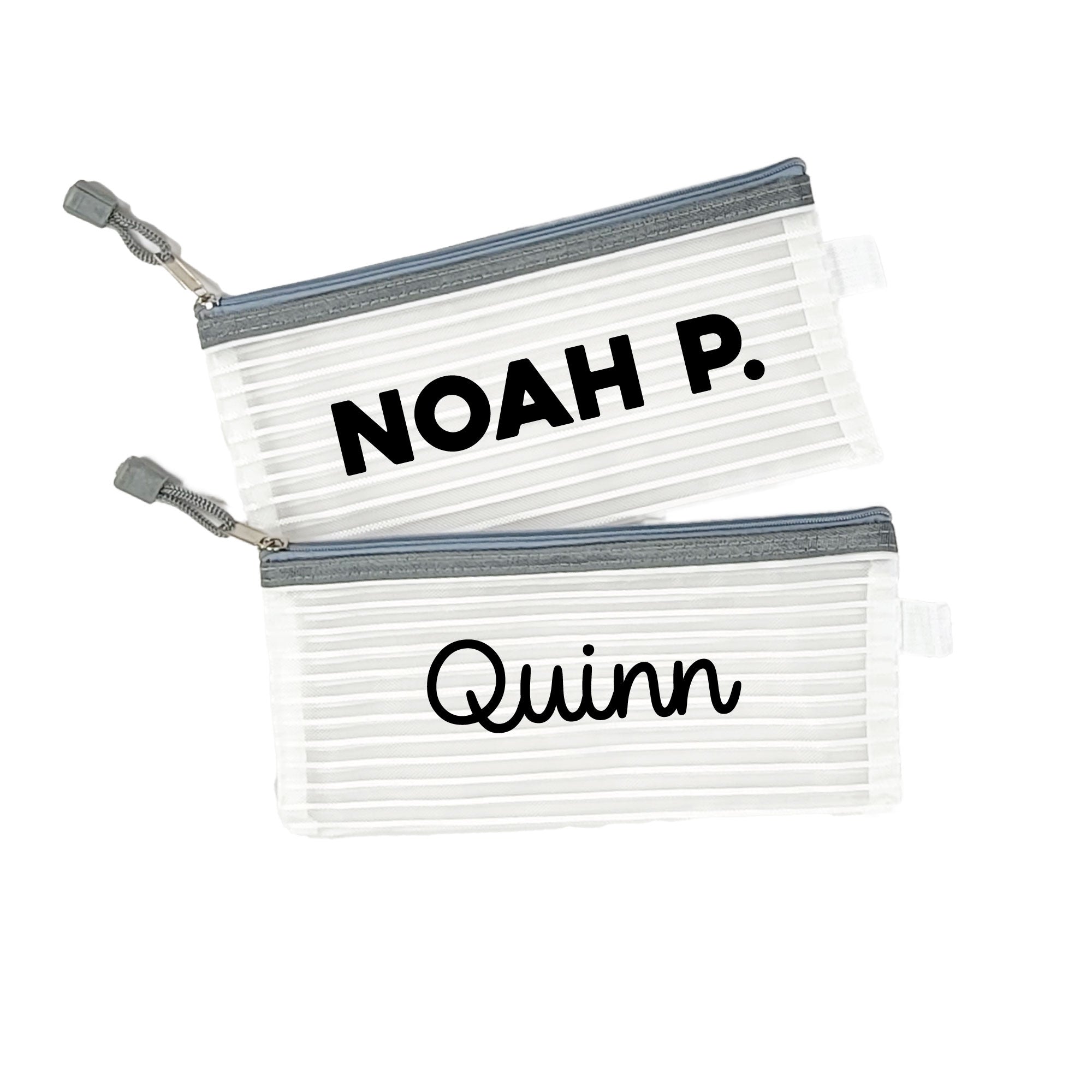 Two grey InchBug personalized zipper pouches with the names 'NOAH P.' and 'Quinn' printed on them.