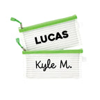 Two green InchBug personalized zipper pouches with the names 'LUCAS' and 'Kyle M.' printed on them.