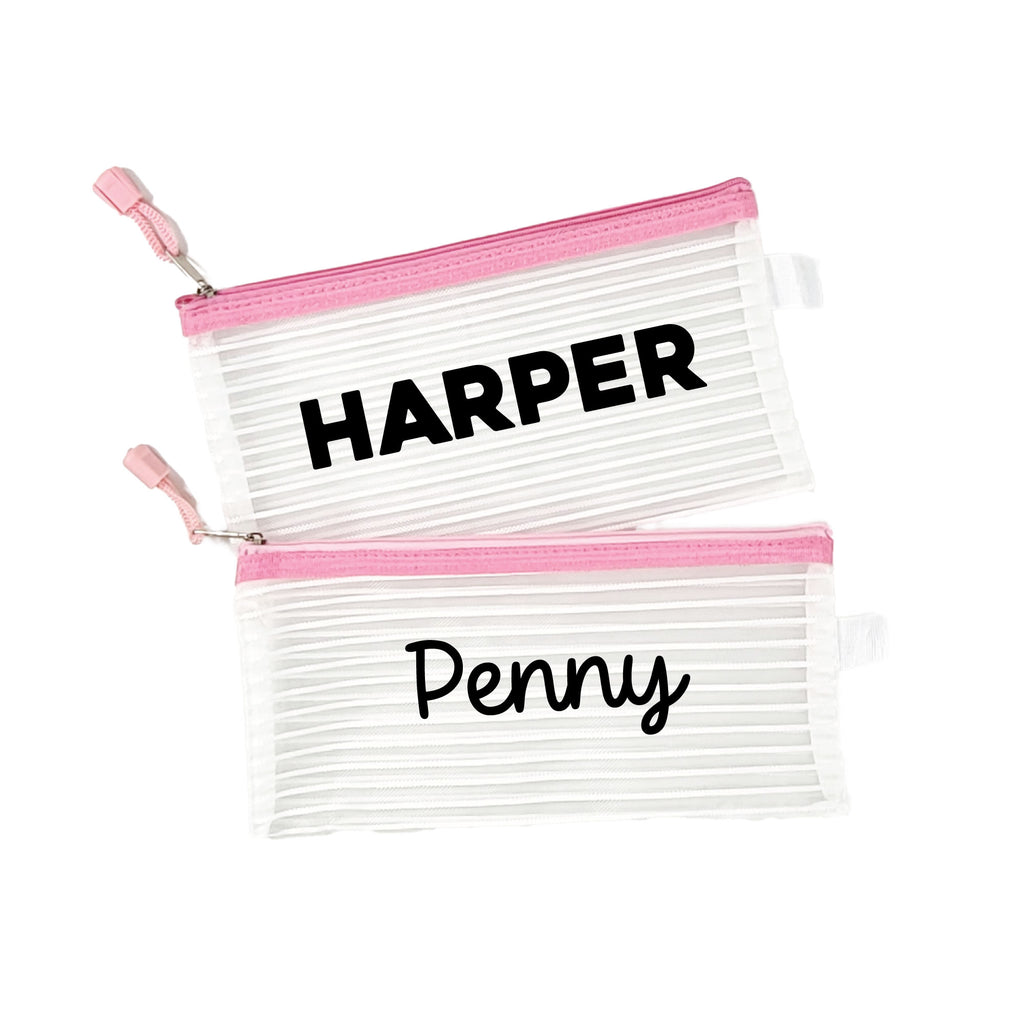 Two pink InchBug personalized zipper pouches with the names 'HARPER' and 'Penny' printed on them.