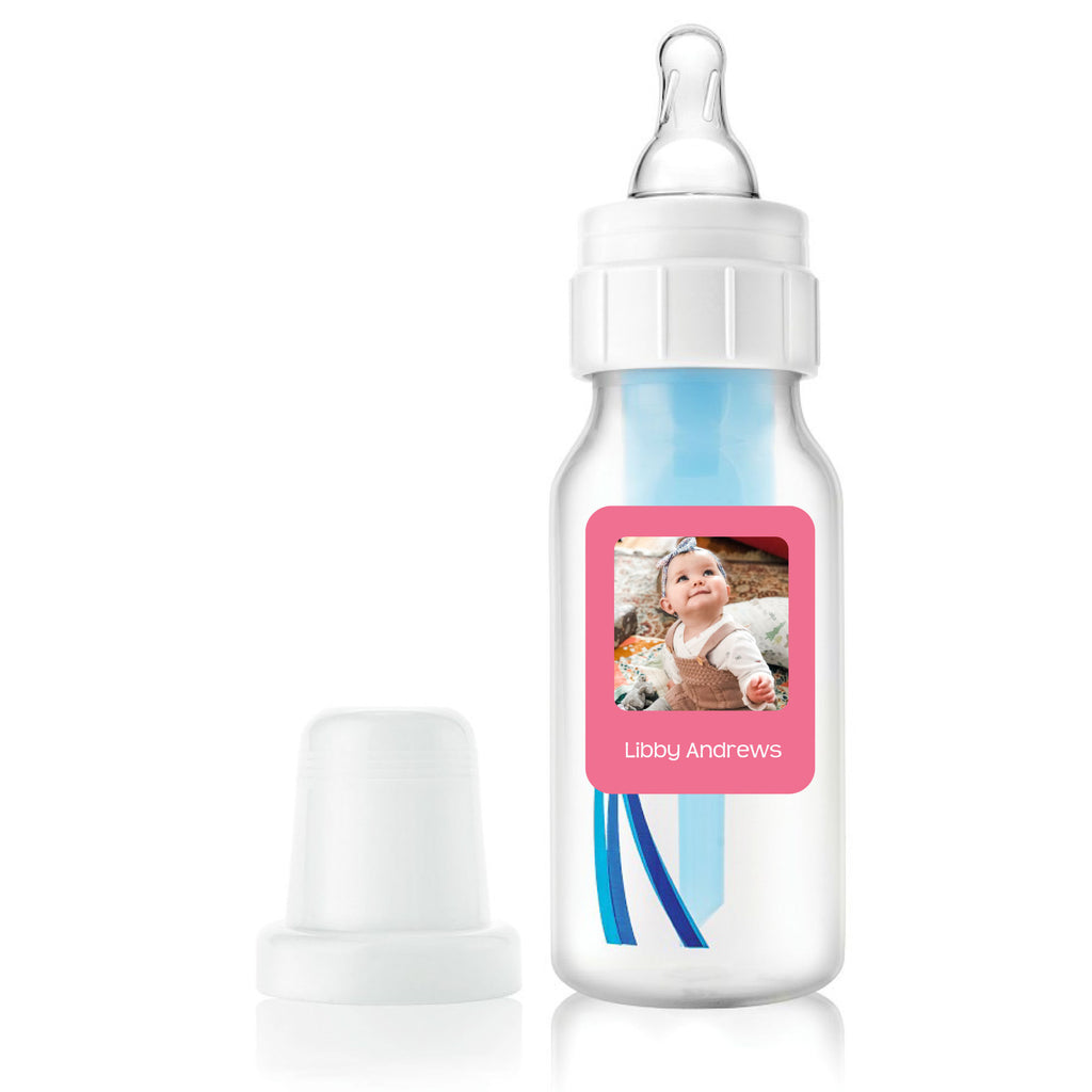 a white baby bottle with a custom pink InchBug label with a baby photo